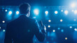 © Stefan - Dynamic Speaker Engaging Audience Under Stage Spotlight at Corporate Event