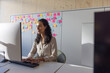 © ReeldealHD images - Businesswoman in an office looking at a computer screen using artificial intelligence