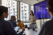 © ReeldealHD images - African American businesswoman giving a presentation in a corporate meeting