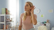 © Krakenimages.com - Woman listening intently in bright bedroom surrounded by baby decor, showcasing a nurturing and attentive atmosphere, evoking warmth and familial comfort.