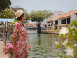 © YURII Seleznov - Young woman in ethnic dress and hat exploring the vibrant streets of Malacca, Malaysia. A blend of cultural heritage, colorful architecture, and tropical charm. Perfect travel and lifestyle moments.