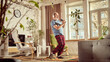 © master1305 - Emotional elderly man in pajamas having fun at home, emotionally singing in tv controller, listening to music in headphones and dancing in living room. Happiness, elderly lifestyle, relaxation concept