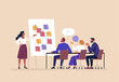 © nadzeya26 - Business Workshop Concept. Vector cartoon illustration of a group of diverse people sitting at a table with a woman standing in front of them next to a board with stickers. Isolated on background