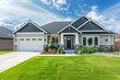 © juliars - New single family home with two car garage, landscaped yard, and blue sky