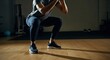 © Alexandr - Man performing a squat exercise in a fitness studio for strength training