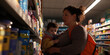 © Lila Patel - Woman and Toddler Shopping in Store Aisle