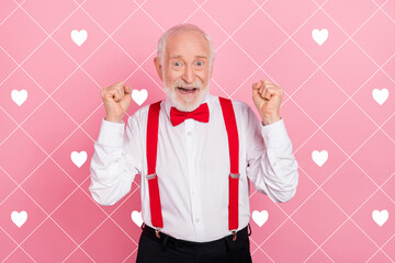 Wall Mural - Portrait of attractive cheerful lucky gray-haired guy having fun rejoicing festal occasion isolated over pink pastel color background