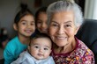 © Milos - This endearing image shows a smiling grandmother surrounded by children in a cozy setting, reflecting a warm family atmosphere filled with love and togetherness.