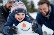 © Milos - A young boy joyfully engages in building a snowman with two adults, showcasing playful interaction and family bonding in a snowy winter landscape full of happiness.