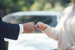 © Kritdanai - Handing Over Car Keys: A close-up shot focuses on the exchange of car keys between a sales representative and a customer, symbolizing a successful car purchase or lease.