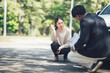 © Kritdanai - Car Accident Report: A concerned woman discusses details with an insurance adjuster near a damaged car, the scene suggesting an accident report being taken.