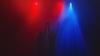 © esti - Silhouetted figures with arms raised under red and blue stage lights.