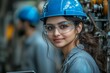 © Smaev - At an industrial facility, two engineers are supervising the work of automated machines alongside an Indian woman and an African American man
