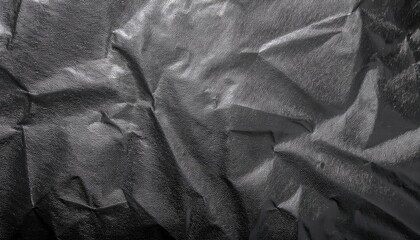 Poster - crumpled textured black fabric with reflective glossy surface, abstract geometric folds for background, texture design usage