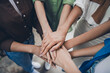 © deagreez - Above view cropped portrait of team ambitious business women pile stack handshake modern interior office indoors