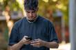 © carballo - young man or teenager using smartphone on the street