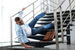 © New Africa - Man falling on stairs in building. Dangerous accident