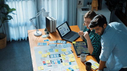 Wall Mural - top view of smart developer compare ux ui design and planning for mobile phone warframe interface de