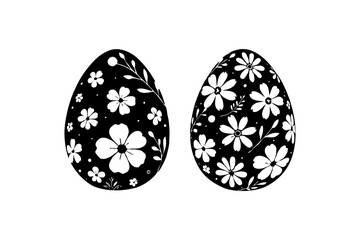 Two black Easter eggs with floral patterns in white, isolated on a clean white background. Concept of Easter decoration