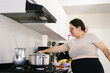 © Carlostock - Pregnant colombian woman cooking lunch for her family