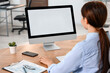 © New Africa - Woman working on computer at table in office
