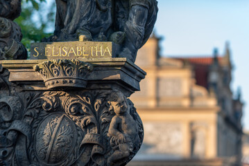 Wall Mural - Religious statue mounted to the balustrade of Charles Bridge in Prague, Czech Republic