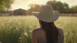 © ibragimova - Woman in field with hat. Girl, field, glare, sun straw, hat, rows, nature. Row of hats in the nature with straw. A girl in a hat glares at the sun as she rows of straw in a nature field. Lifestyle a.
