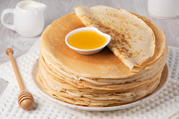 Stack of traditional russian pancakes blini on a white table. Homemade russian thin pancakes blini. Russian food, russian kitchen