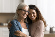 © fizkes - Portrait affectionate caring young woman grown up child daughter hold in arms hug embrace with warmth love elderly mom pensioner feel grateful to beloved aged parent for support kindness understanding