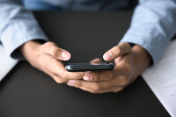 modern technology in business communication. close up cropped shot digital mobile telephone at young