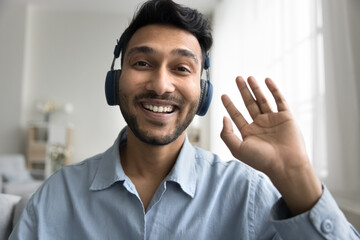 hello there. charismatic smiling millennial male professional vlogger influencer in modern earphones