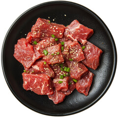 Wall Mural - Seasoned raw beef cubes with green onions on a black plate ready for preparation or marinating in the kitchen, seasoned raw beef food on black plate isolated on transparent background