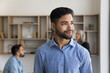© fizkes - Confident man employee wearing casual shirt standing in office, exude professionalism and success, feeling contentment, looks satisfied with his work done or project accomplishment, head shot portrait