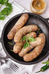 Wall Mural - Frying pan of tasty homemade sausages on light background