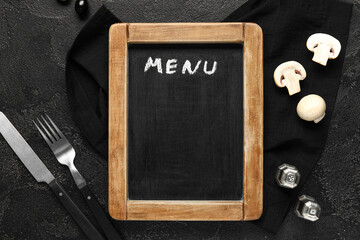 Canvas Print - Composition with blank menu board, cutlery, spices and vegetables on dark background