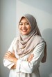© My Ai - Woman of Southeast Asian wearing a patterned hijab smiling warmly against a gray background