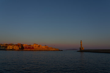 Wall Mural - Before sunrise the sky starts to turn blue and first rays of sun hit buildings across bay