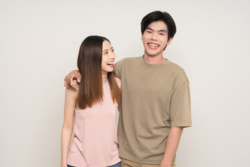 Wall Mural - Happy asian couple attractive in various action gesture standing on isolated white background. Cheerful Smiling young man and woman