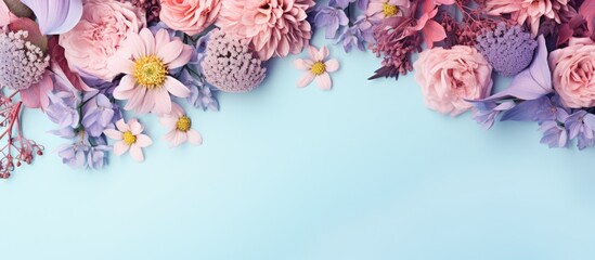 Leinwandbilder - Top-down view of pink and purple flower arrangement on pastel blue background with ample copy space, featuring soft shades of pink and lavender.