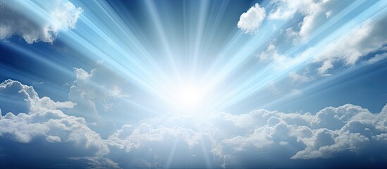 Poster - Radiant sunlight breaking through blue skies with soft white clouds in the foreground creating a serene and uplifting atmosphere.