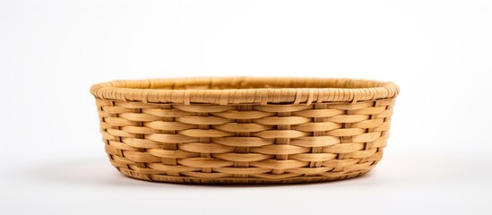 Fototapete - Woven bamboo basket in natural tan color placed horizontally on a clean white background showcasing its empty interior and intricate weave design.