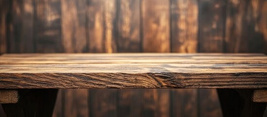 Leinwandbilder - Rustic wooden table with rich brown tones positioned centrally against a softly blurred dark wooden background ideal for product showcasing.