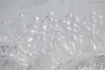 Wall Mural - bubbles of methane gas in frozen ice abstract background
