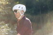 © Cavan Images - Close-up of a cyclist in a white helmet, reflective sunglasses