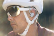 © Cavan Images - Male biker in golden light, wearing protective gear and earbuds.