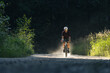 © Cavan Images - Solo biker on a dirt trail in a forest, exploring fitness and nature.