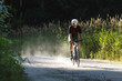 © Cavan Images - Cycling through a forest road, blending endurance, and adventure