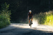 © Cavan Images - Gravel biker riding a quiet forest path, capturing adventure.