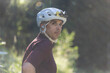 © Cavan Images - Male biker in golden light, wearing protective gear and earbuds.