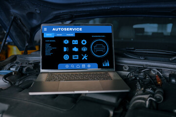 Fototapete - Open laptop displaying autoservice diagnostic software on a car engine, representing advanced vehicle maintenance, repair, and modern automotive technology